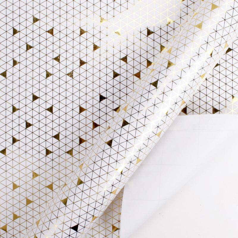 White And Gold Foil Triangle Wrapping Paper Roll, partially unrolled to show mini gold triangle design covers whole surface.