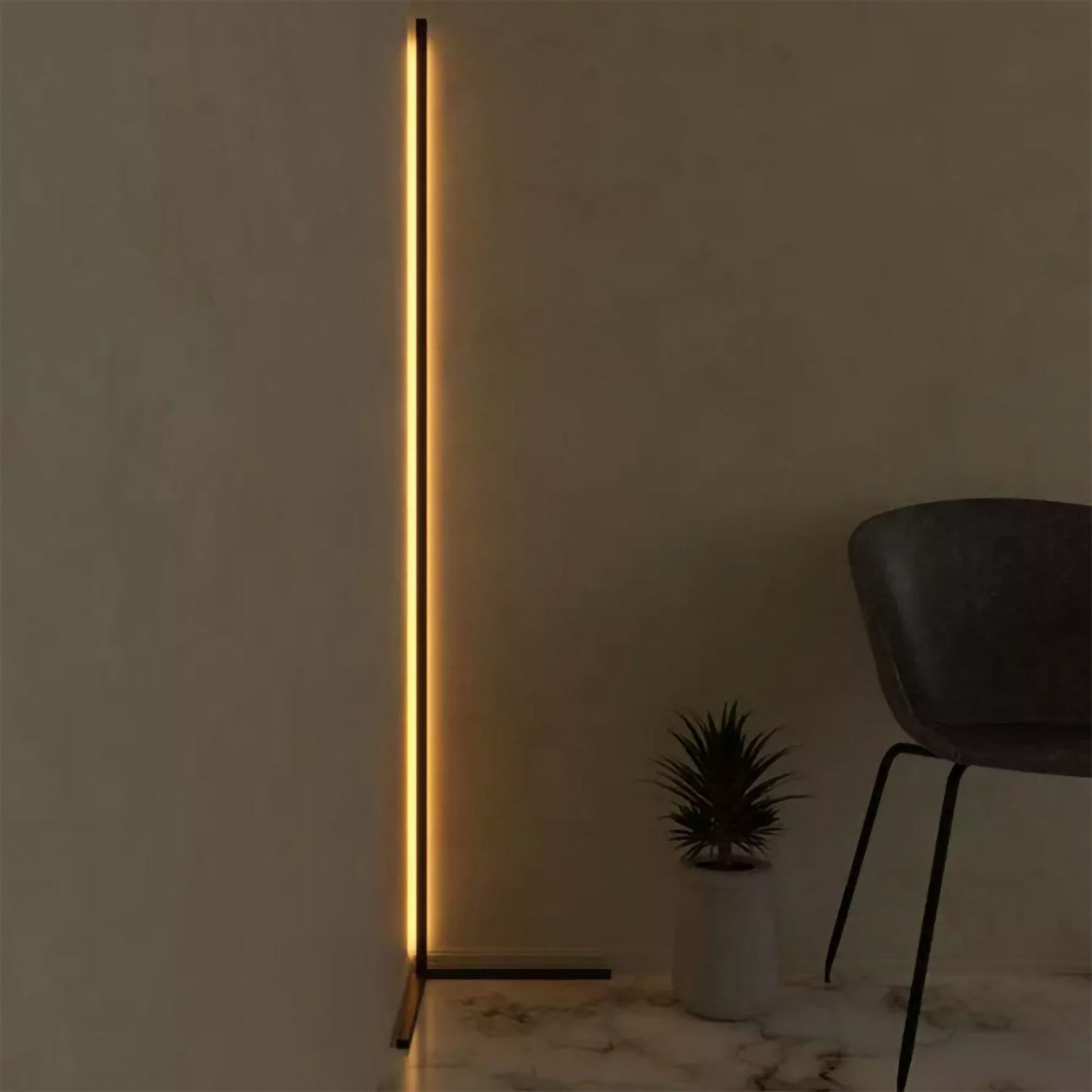 Minimalist Corner RGB floor lamp, lit with warm white light, Illuminating corner of a room.