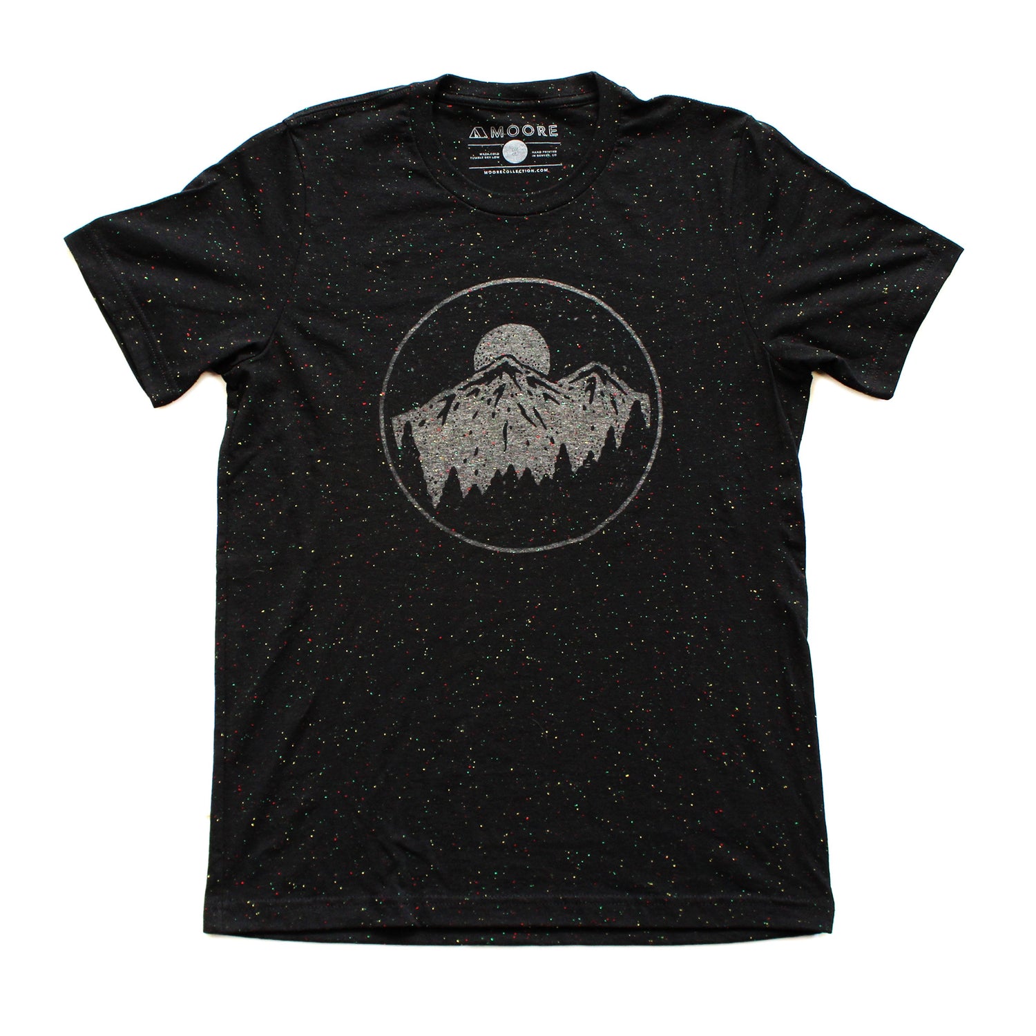 Black with white speckle unisex tee shirt, featuring moon over mountains graphic, printed on the front, laid out flat.