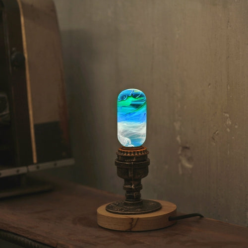 Oval decorative resin bulb with blue, white, and green horizontal streaks inside, sits lit on vintage brass and wood base.