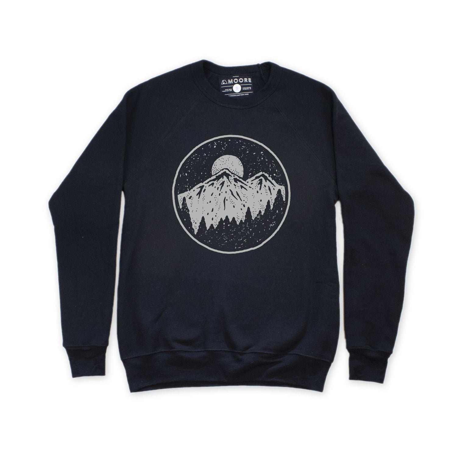 Black crew neck sweatshirt with moonrise over mountain range graphic, laid out flat.